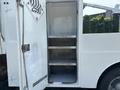 A 2006 Sterling Acterra truck with an open door revealing three empty shelves inside the cargo area