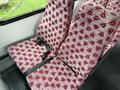 Two patterned seats with seatbelts in a 2015 Ford Econoline van interior