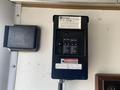 A 2008 Wells Industries Inc EW1422 control panel featuring multiple circuit breakers and a label with specifications attached to a wall