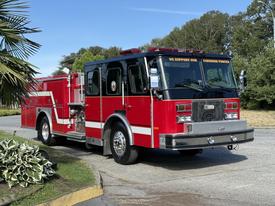 A red 1992 Emergency One Typhoon Superior fire truck with chrome accents and "We Support Our Canadian Forces" written on the front