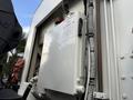 A white hydraulic oil reservoir with a caution sign labeled "HYDRAULIC OIL ONLY" attached to the side of a 2010 Autocar Xpeditor truck