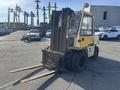 A yellow 1993 Hyster H80XL forklift with a sturdy metal frame and dual forks positioned for lifting objects. The tires are rugged for outdoor use