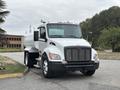 A 2025 Peterbilt 536 truck with a white body featuring black accents a large front grille and chrome details equipped for commercial use