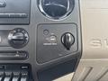 Dashboard controls of a 2009 Ford F-450 Super Duty featuring air conditioning dials and a passenger airbag switch