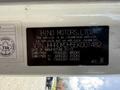 Black vehicle information plate for a 2014 Hino 195 featuring details on vehicle weight and manufacturing date