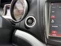 A close-up of the ignition button in a 2013 Dodge Journey with controls and dashboard display visible