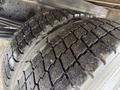 Close-up of a tire on a 2014 Hino 195 showing detailed tread pattern with dirt and wear visible on the rubber surface