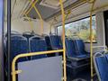 Interior of a 2016 Grande West Vicinity bus featuring blue patterned seats and yellow handrails with an empty aisle showing no passengers