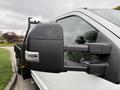 Close-up of the side mirror of a 2020 Ford F-550 with a black housing and integrated light visible