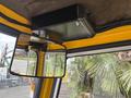 Interior view of a 2004 Bombardier SW48 showing a rearview mirror and a mounted black device above the mirror