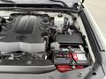 A 2018 Toyota 4Runner engine compartment showing the engine cover battery and various engine components