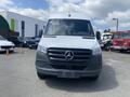 2025 Mercedes-Benz Sprinter van in the foreground with a prominent grille featuring the Mercedes logo and a sleek, modern design