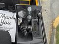 Control panel of a 2004 Bombardier SW48 featuring gauges levers and a key ignition