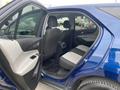A blue 2022 Chevrolet Equinox with the rear door open displaying the backseat area featuring two seats with a split fold design and black and gray upholstery