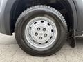A close-up view of a silver wheel with five circular holes and a black Michelin tire on a 2020 RAM Promaster vehicle