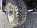 Close-up of a heavily treaded rubber tire from a 2023 Bitimec SC415 with visible dirt and wear on the surface