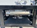 A 2022 Isuzu NRR with visible rear components including a hitch and safety features, showcasing its design for utility and transportation