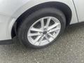 Close-up of a silver 2018 Ford Focus wheel and tire showcasing a multi-spoke alloy rim and a black tire with visible tread