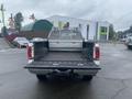 A 2005 Ford F-350 SD with an open bed showing a metal toolbox in the center