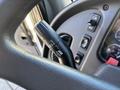 A close-up view of the control lever on a 2005 Freightliner M2 106 with labels for off, low, and high beam settings