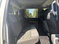 Interior view of a 2023 Ford F-350 SD showing the rear seating area with gray cloth seats and a spacious layout