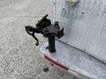 A black hitch attachment mounted on the back of a 2005 Freightliner M2 106 truck made of metal with a textured finish