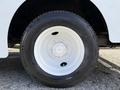 Close-up view of a white wheel from a 2017 Freightliner MT45 featuring a five-bolt pattern and a black tire with the brand name visible