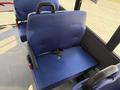 A blue fabric seat in a vehicle with a black firearm placed on it