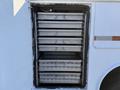 A 2009 Ford F-550 service vehicle with multiple metal storage drawers lined up in a compartment