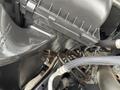Close-up of the engine compartment of a 2015 RAM 2500 showing various components including hoses and an air intake assembly