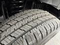Close-up view of a tire tread on a 2022 Ford E-450 showing detailed patterns and slight wear on the rubber surface
