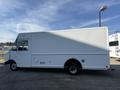A white 2012 Ford Econoline delivery truck with a boxy cargo area and a single rear wheel on each side