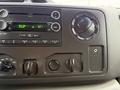 Dashboard controls and audio system of a 2019 Ford Econoline featuring knobs and buttons for sound and climate settings