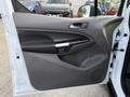 A white 2020 Ford Transit Connect van door with a black interior panel featuring a door handle and speaker