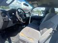 Interior of a 2016 Ford F-350 SD showing the front driver's seat and dashboard with visible wear on the seat upholstery