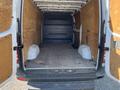 Interior view of a 2016 Mercedes-Benz Sprinter van showing a spacious cargo area with wooden paneling and a bare floor