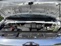 The engine compartment of a 2019 Ford Econoline with visible components including the battery air intake and coolant reservoir