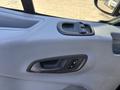 Interior view of a 2016 Ford Transit 150 door panel featuring a door handle and power window controls