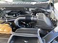 Engine compartment of a 2015 Ford F-150 featuring the air intake system and coolant reservoir