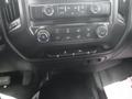 Dashboard controls of a 2015 Chevrolet Silverado 1500 featuring air conditioning buttons temperature settings and radio controls