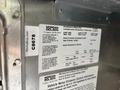 A metal plate displaying vehicle specifications and information for a 2020 Freightliner MT45 including vehicle identification number and emissions control details