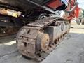 A close-up of the tracked undercarriage of a 2018 Sandvik Ranger DX800 featuring metal tracks and large wheels