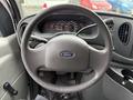 Steering wheel and dashboard of a 2007 Ford E-350 with gauges and controls visible