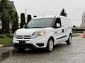A white 2017 RAM ProMaster City van is parked with its side facing the viewer featuring a compact design and distinctive front grille