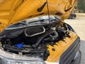 A 2018 Ford Transit-350 with its hood raised exposing the engine compartment displaying various components including an air intake and fluid reservoirs