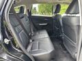 Interior view of the back seat of a 2014 Honda CR-V featuring black leather upholstery with two seats and seatbelts