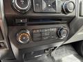 Climate control and audio system controls of a 2018 Ford F-150 featuring knobs for temperature volume and air conditioning settings