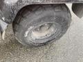 A close-up of a tire from a 2010 Kubota RTV 900 featuring aggressive tread and a metallic wheel hub