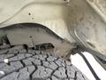 A close-up view of a 2022 GMC Savana's wheel well showing the tire tread and the inner structure of the vehicle's chassis