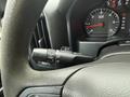 Close-up of a 2015 GMC Sierra 1500 steering wheel with a multifunction control stalk for windshield wipers and lights